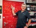 Who's who: The entrance door to the workshop collects signatures from people from all over the cycling world.