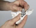 Reassemble the mechanism and thoroughly wipe off any excess lubricant.