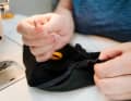 Manual work on the defective waistband of a pair of cycling shorts