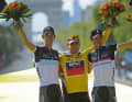 Andy Schleck (à g.) et son frère Fränk (à dr.) avec le vainqueur Cadel Evans sur le podium du Tour de France 2011.