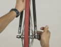  2. stand in front of the bike for installation, hold it slightly up by the fork and place the dropouts of the fork on the axle of the front wheel hub. The quick-release lever is on the right. Tighten the nut again until the lever builds up significant resistance when closing and check that the wheel is centred between the fork legs. Close the brake release lever.
