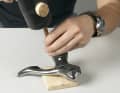 5. push the retaining bolt out of the hole using a 4-millimetre punch or a hexagon socket. If the bolt cannot be moved easily, first unscrew the grub screw a little further. If the axle is still tight, place the handle flat on a wooden board that provides clearance in the area of the bolt. Drive out the bolt by tapping it lightly with a rubber mallet.
