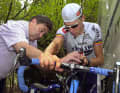 Eddy Merckcx (l.) inspects the bike of his son Axel Merckx at the Tour de France 2001.