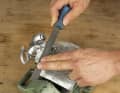 3. file the material with a relatively fine and flat file until the coarsest scratches and grooves have been levelled out. Run the file in long strokes and cover as large an area as possible each time so that you do not work any edges or indentations into the surface.