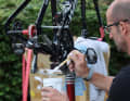 Everything for speed: Guido Scheeren, mechanic at Team Quick-Step Alpha Vinyl, prepares the chains of the time trial bikes with Teflon powder
