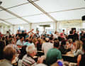 The TOUR team celebrates its second place in a packed beer tent 