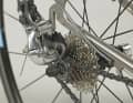 3. to fit the rear wheel, stand behind the side of the bike and grasp the left seat stay. Lift the frame high enough so that you can thread in the rear wheel from behind. Bring the frame and wheel together so that the chain comes to rest on the smallest sprocket.