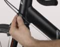 5. turn the crank and shift to the large chainring. If the chain does not climb, it is because the tension is too low or the end stop screw is screwed in too far.
the end stop screw is screwed in too far. Tension the cable with the tensioning screw on the head tube or down tube by half a turn anti-clockwise and try again. If this does not work and you feel hard resistance on the shift lever, unscrew the external end stop screw slightly. Try shifting to the large gear again. Tighten the cable until it works without any problems.