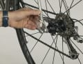 3. to open the quick-release lever, pull the lever while resting your hand on a fixed part of the wheel with your thumb.