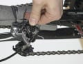 5. hold the derailleur with one hand so that it does not fall down, loosen the screw and remove it. Protect the chain stay either with bubble wrap or foam tubes (e.g. from hot water pipes). Tie the rear derailleur to the centre of the protected strut.