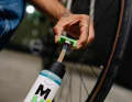 The bottle contains a filling tube and a tool for unscrewing the valve core.