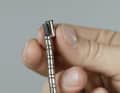 1. slide the beads threaded onto the plastic tube to the end so that you can slide on the end sleeve and possibly a single bead. The plastic tube should end two to three millimetres inside the end piece. There are shorter sleeves at one end of the pull than at the other; the shorter ones should point towards the handle.