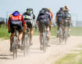 The dust on the gravel roads makes some of the riders disappear into clouds