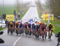 A large leading group breaks away from the peloton