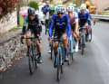A 14-rider breakaway group pulls away from the peloton