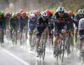 After initially dry weather, the peloton got out their rain jackets and it got wetter