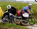 The wet gravel tracks also push the support bikes to their limits ... and beyond