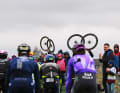 A typical picture at the classic races on cobblestones - the helpers hold their bikes in the air to draw attention to themselves