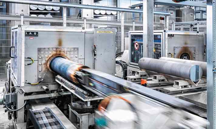   Alu-Felgen: Ein großer Teil des Herstellungsprozesses ist automatisiert. Am Anfang wird aus der erhitzten, plastischen Alu-Legierung ein Endlosprofil in großen Extrudern gepresst.
