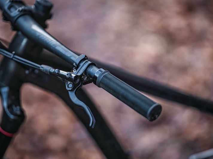 Die langen Bremsgriffe der güns­tigen Shimano-Stopper wirken wenig wertig und klappern in der Abfahrt.
