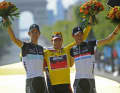Andy Schleck (l.) und Bruder Fränk (r.) mit dem Sieger Cadel Evans auf dem Podium der Tour de France 2011.